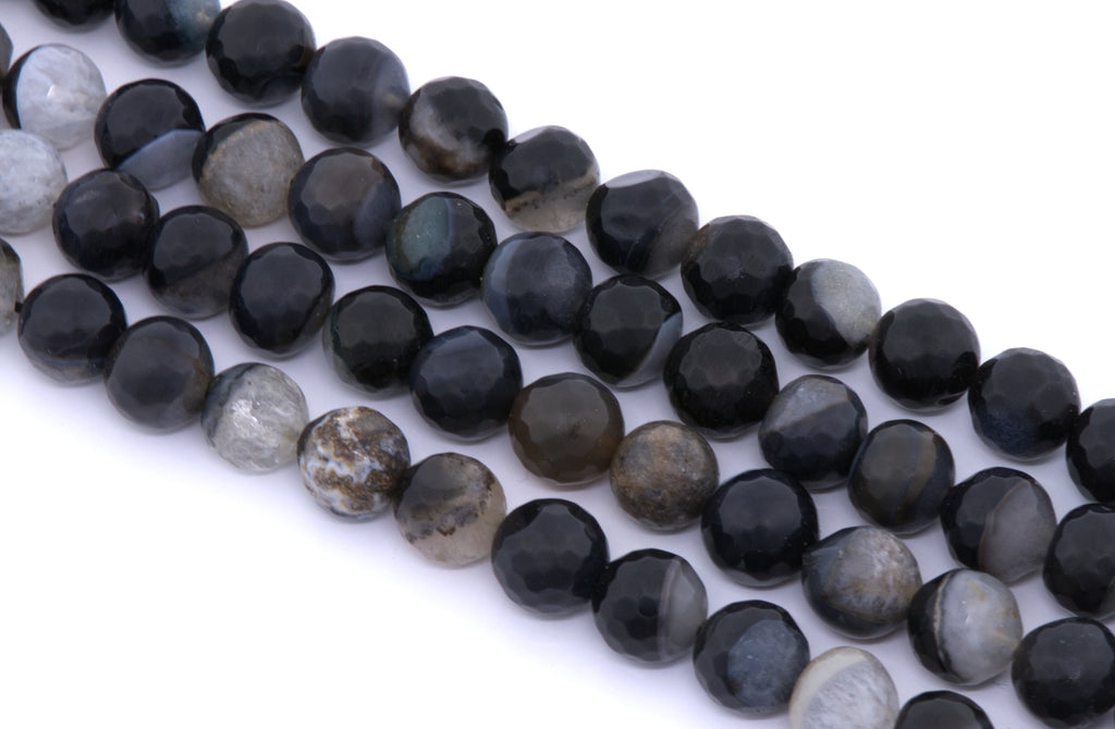 Faceted round agate beads in black and dark gray, arranged in four diagonal rows on a white background.