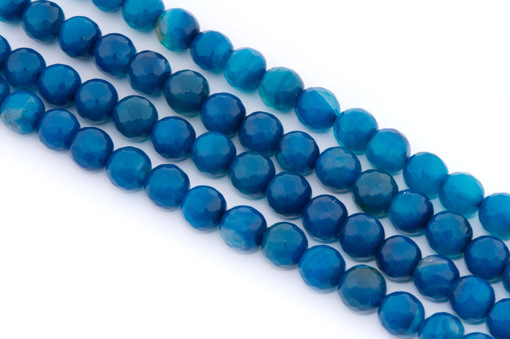 Faceted round blue agate beads arranged in four parallel strands on a plain white background.