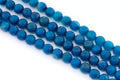 Faceted round blue agate beads arranged in four parallel strands on a plain white background.