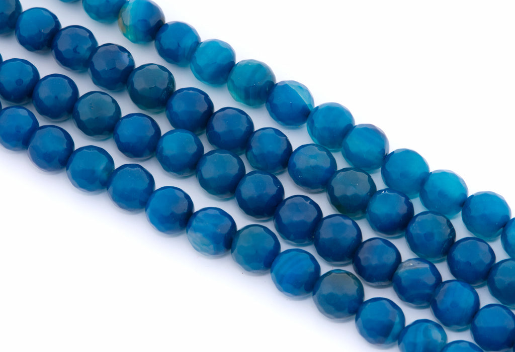 Faceted round blue agate beads arranged in four parallel strands on a plain white background.