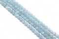 Light blue faceted diamond cut agate beads arranged in four diagonal strands against a solid white background.