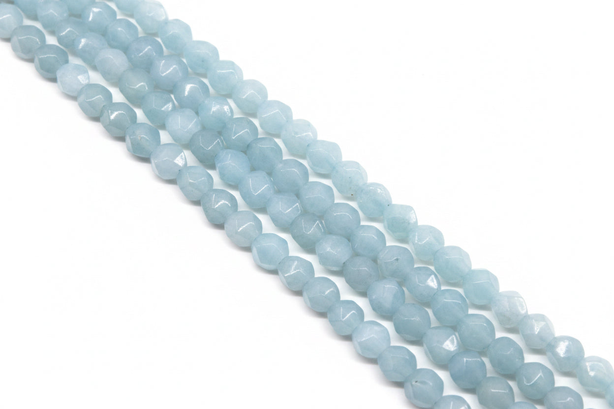 Light blue faceted diamond cut agate beads arranged in four diagonal strands against a solid white background.