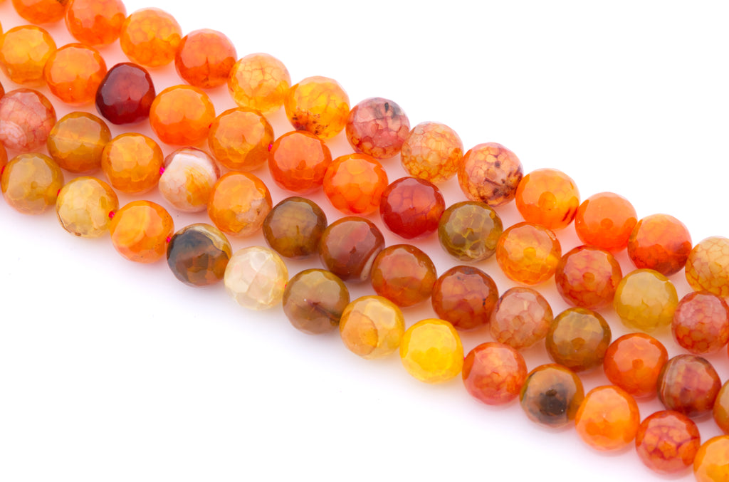 Faceted round gemstone beads in warm orange, red, brown, and yellow tones, arranged in diagonal rows on a white background.