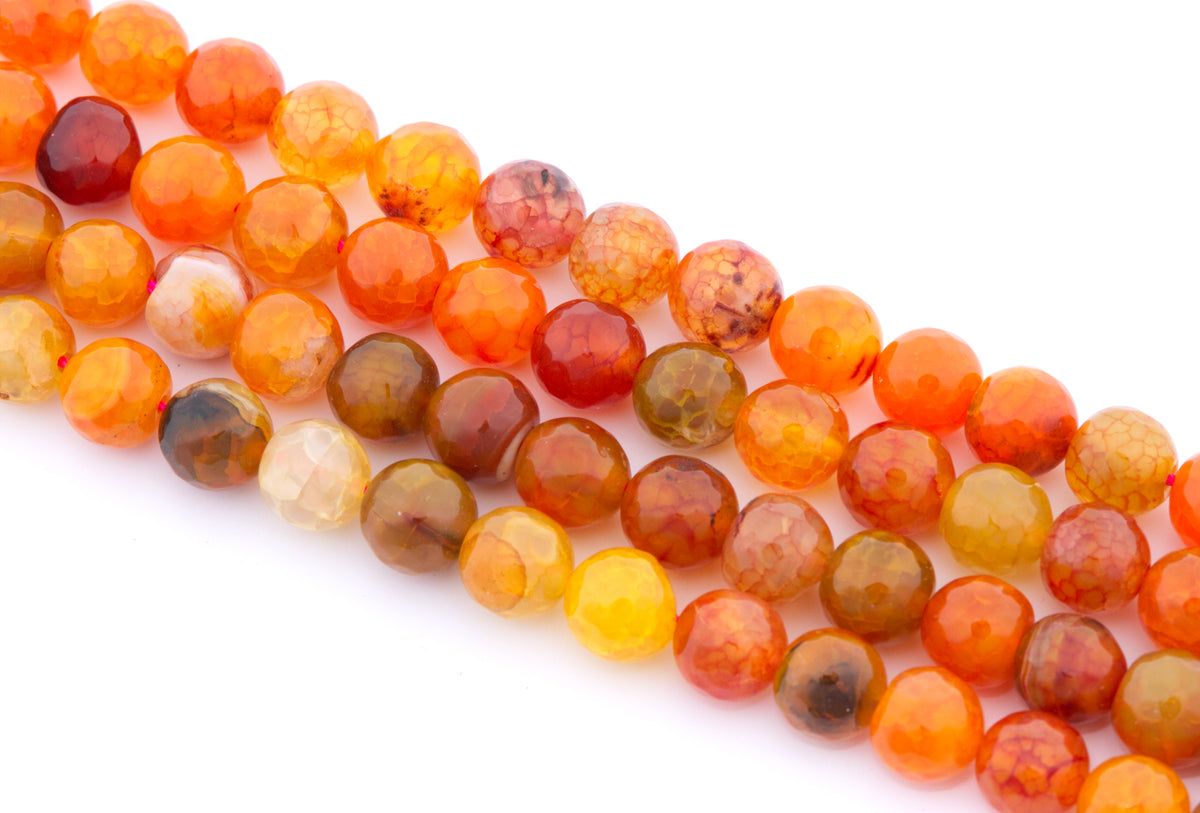 Faceted round gemstone beads in warm orange, red, brown, and yellow tones, arranged in diagonal rows on a white background.