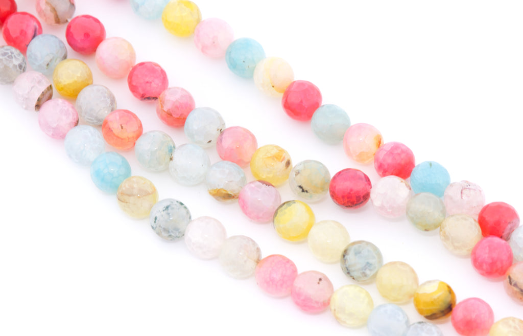 Multicolor round faceted agate beads in pink, yellow, blue, white, and gray, arranged in diagonal rows on a white background.