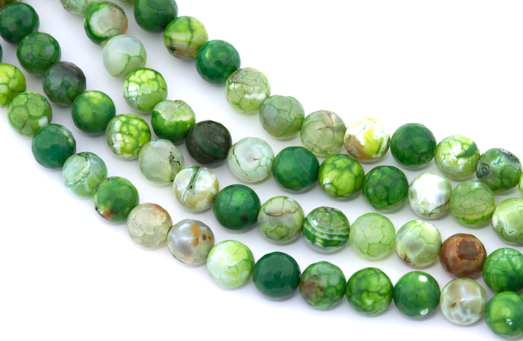 Green faceted round agate beads, arranged in four strands on a white background.