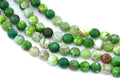 Green faceted round agate beads, arranged in four strands on a white background.