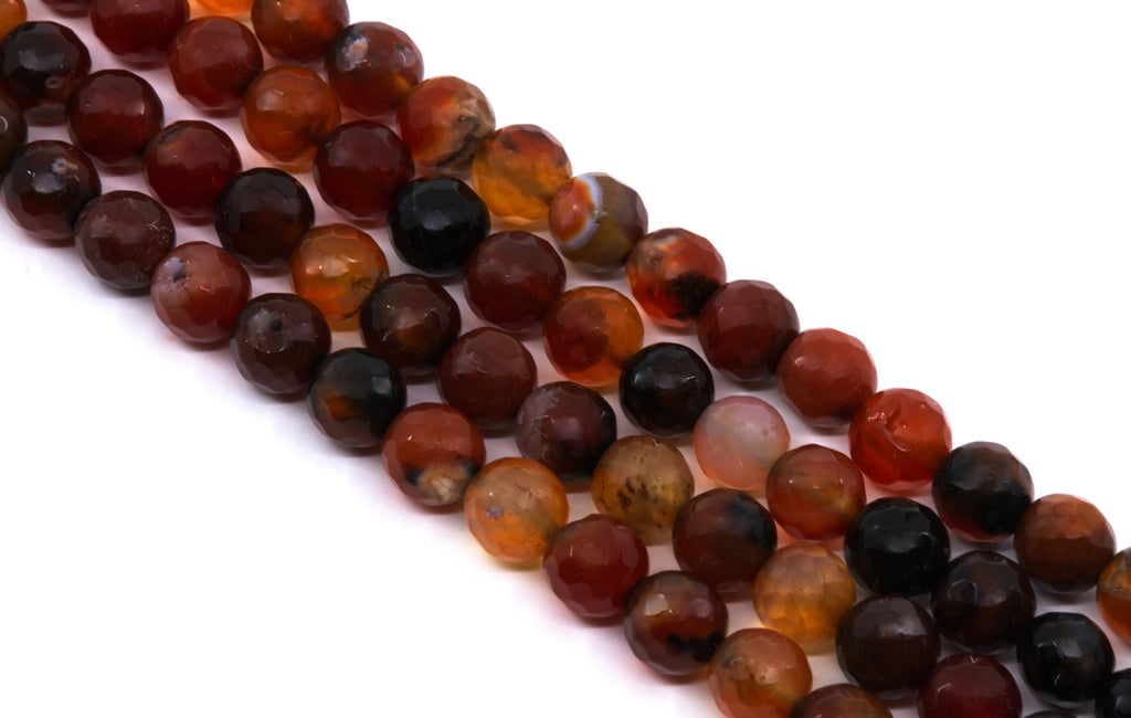 Faceted round beads in a mix of translucent amber, deep red, and dark black-brown tones, arranged diagonally on a plain white background.