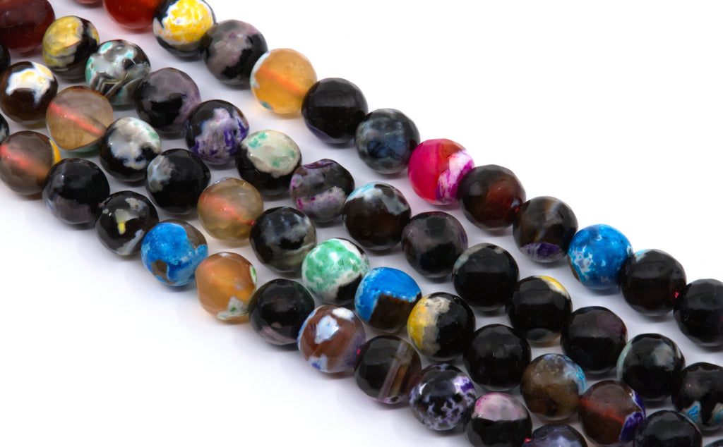 Multiple strands of polished round faceted agate  beads in assorted colors and marbled patterns, including black, blue, purple, green, orange, and pink, arranged diagonally on a white background.