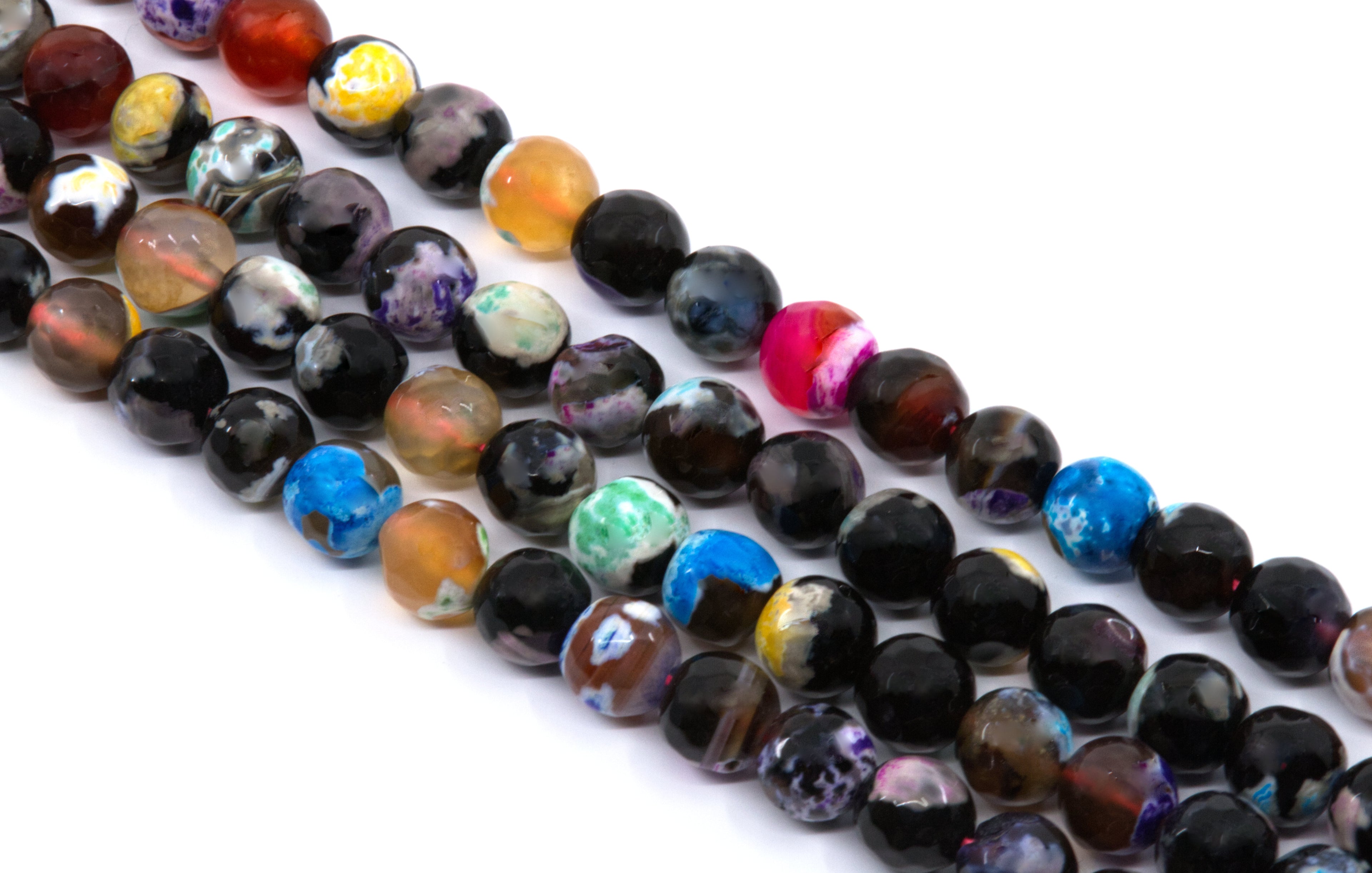 Multiple strands of polished round faceted agate  beads in assorted colors and marbled patterns, including black, blue, purple, green, orange, and pink, arranged diagonally on a white background.