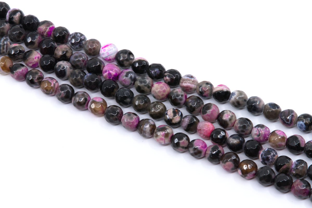 Faceted round agate beads on strands, featuring a pink and black coloring, displayed on a clean white background.