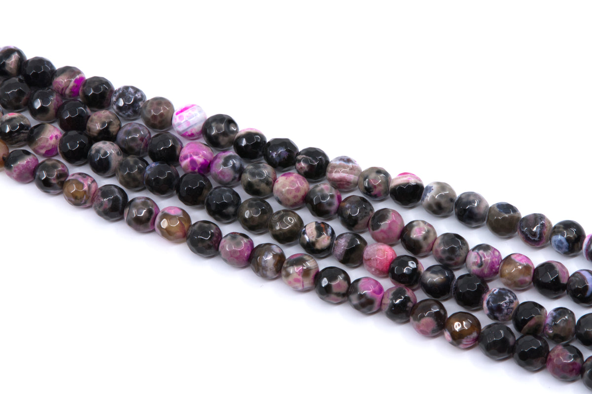 Faceted round agate beads on strands, featuring a pink and black coloring, displayed on a clean white background.