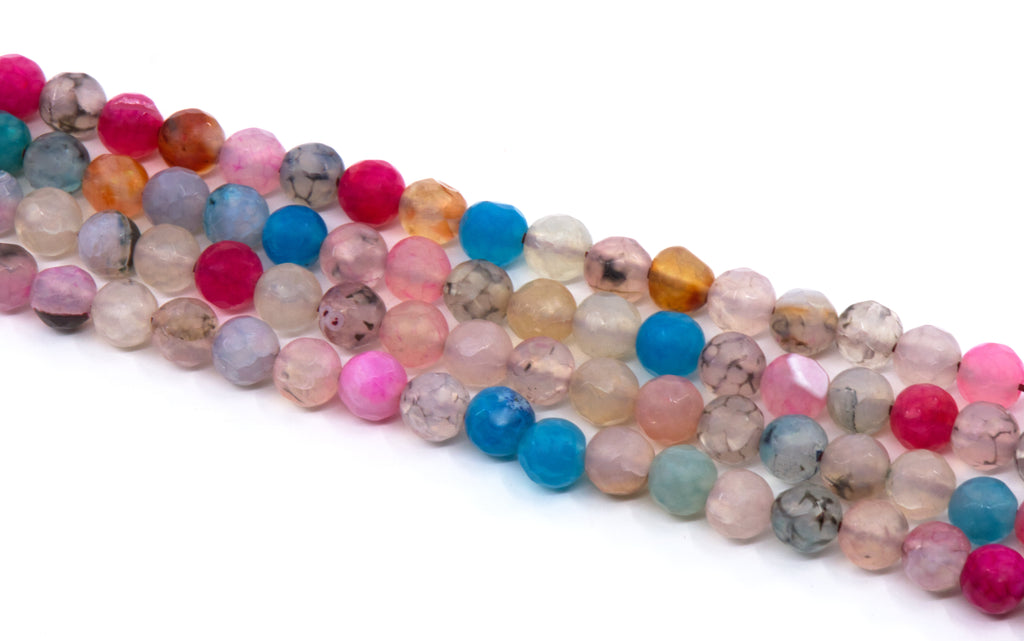Multiple strands of faceted round agate beads in assorted pastel and opaque colors, including pink, blue, peach, gray, and clear varieties, arranged diagonally on a white background.
