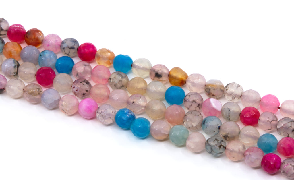 Multiple strands of faceted round agate beads in assorted pastel and opaque colors, including pink, blue, peach, gray, and clear varieties, arranged diagonally on a white background.