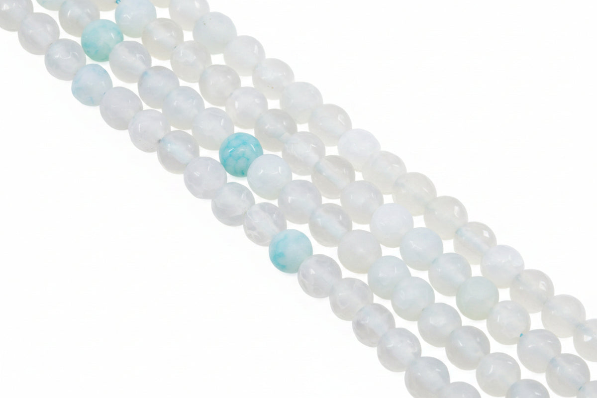A close-up diagonal view of multiple strands of round gray beads with a few light blue marbled accent beads, photographed on a clean white background.