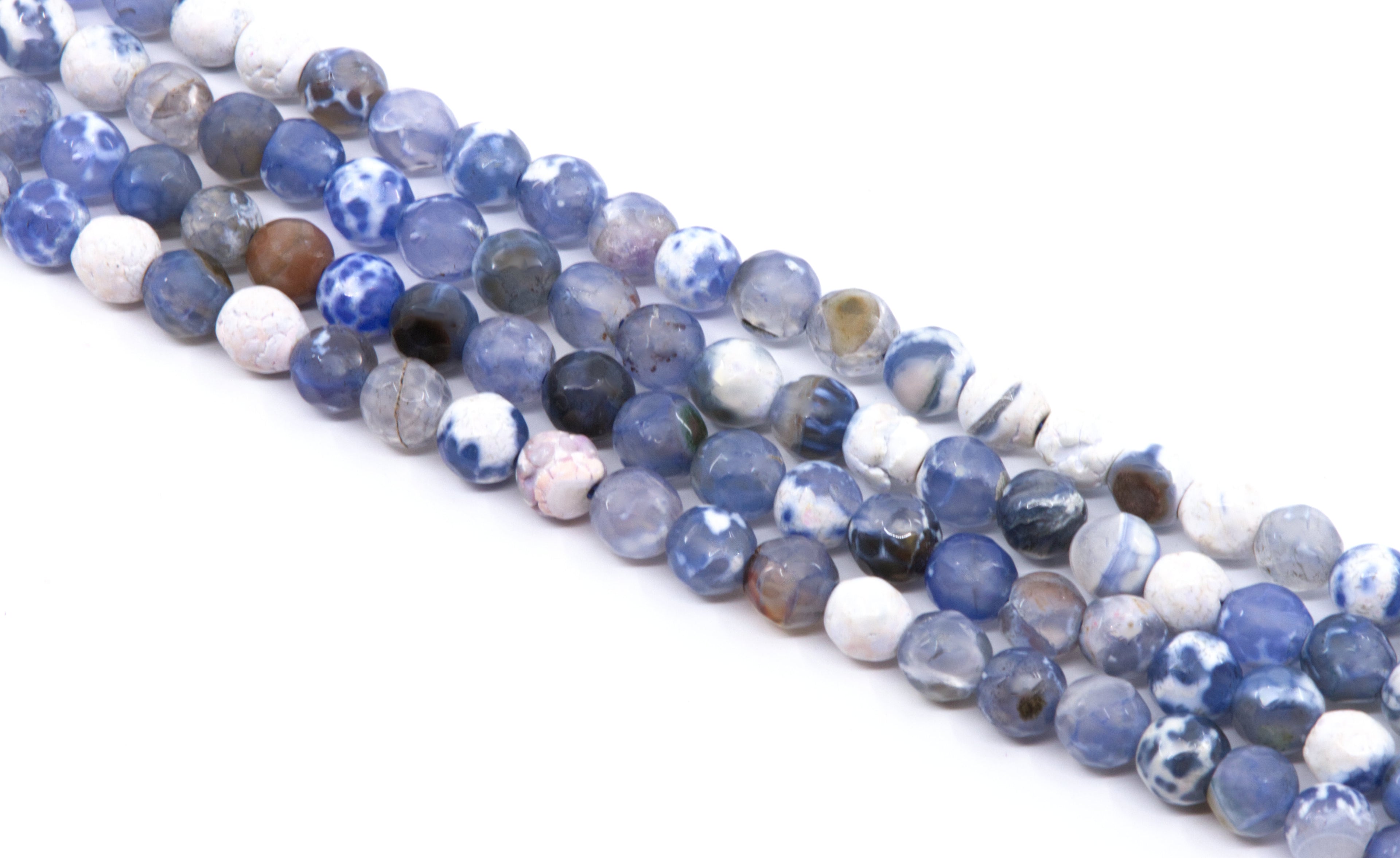 Multiple strands of faceted round agate beads in shades blue and white, arranged diagonally on a plain white background.