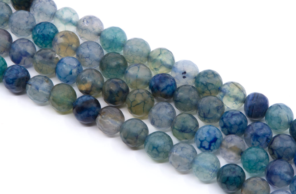 four strands of round, faceted agate beads in shades of blue, teal, green, and gray, arranged diagonally on a white background.