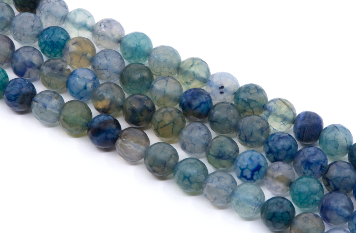 four strands of round, faceted agate beads in shades of blue, teal, green, and gray, arranged diagonally on a white background.