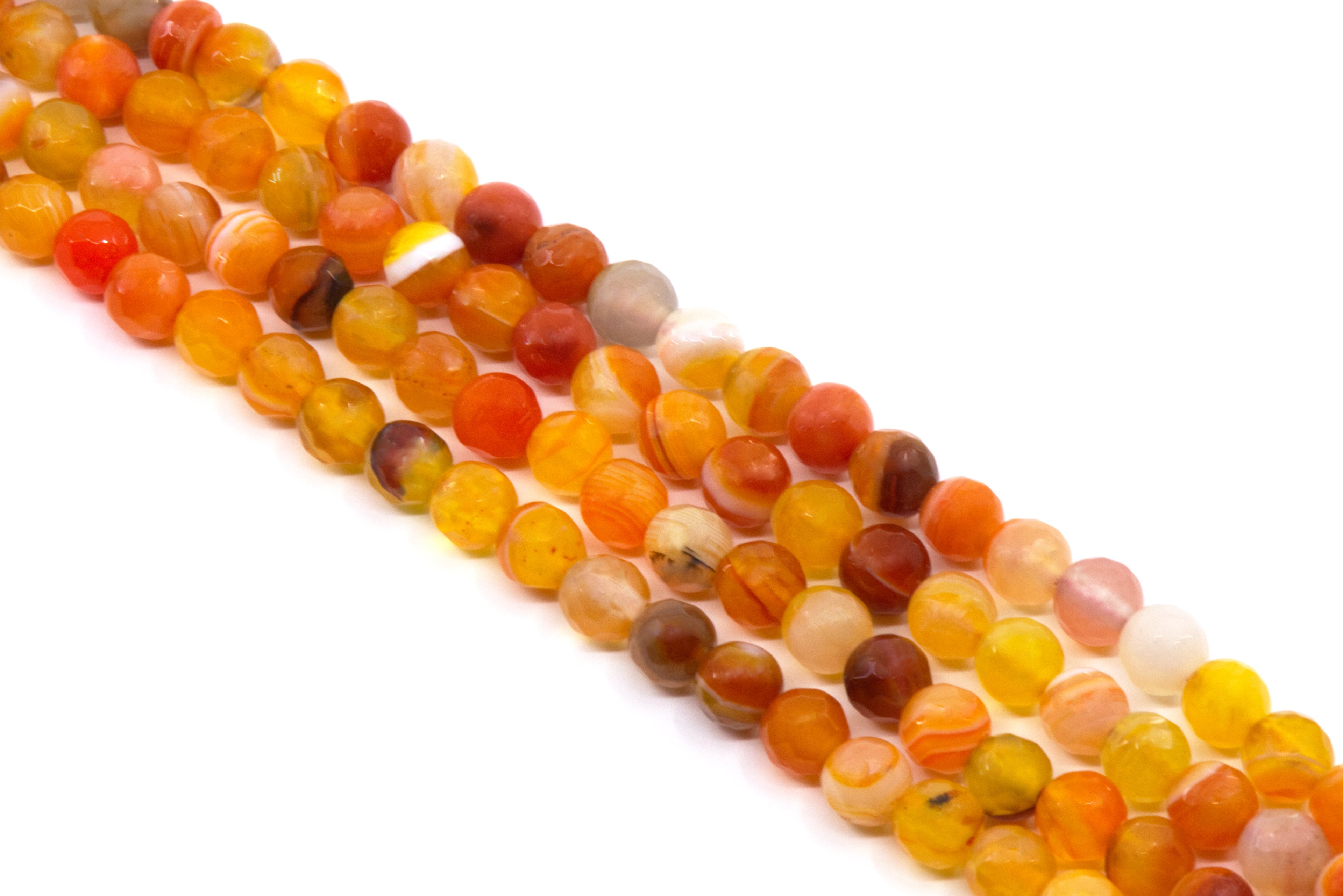 Multiple strands of round faceted agate bead charms in warm orange, yellow, red, and brown tones, arranged diagonally on a plain white background.