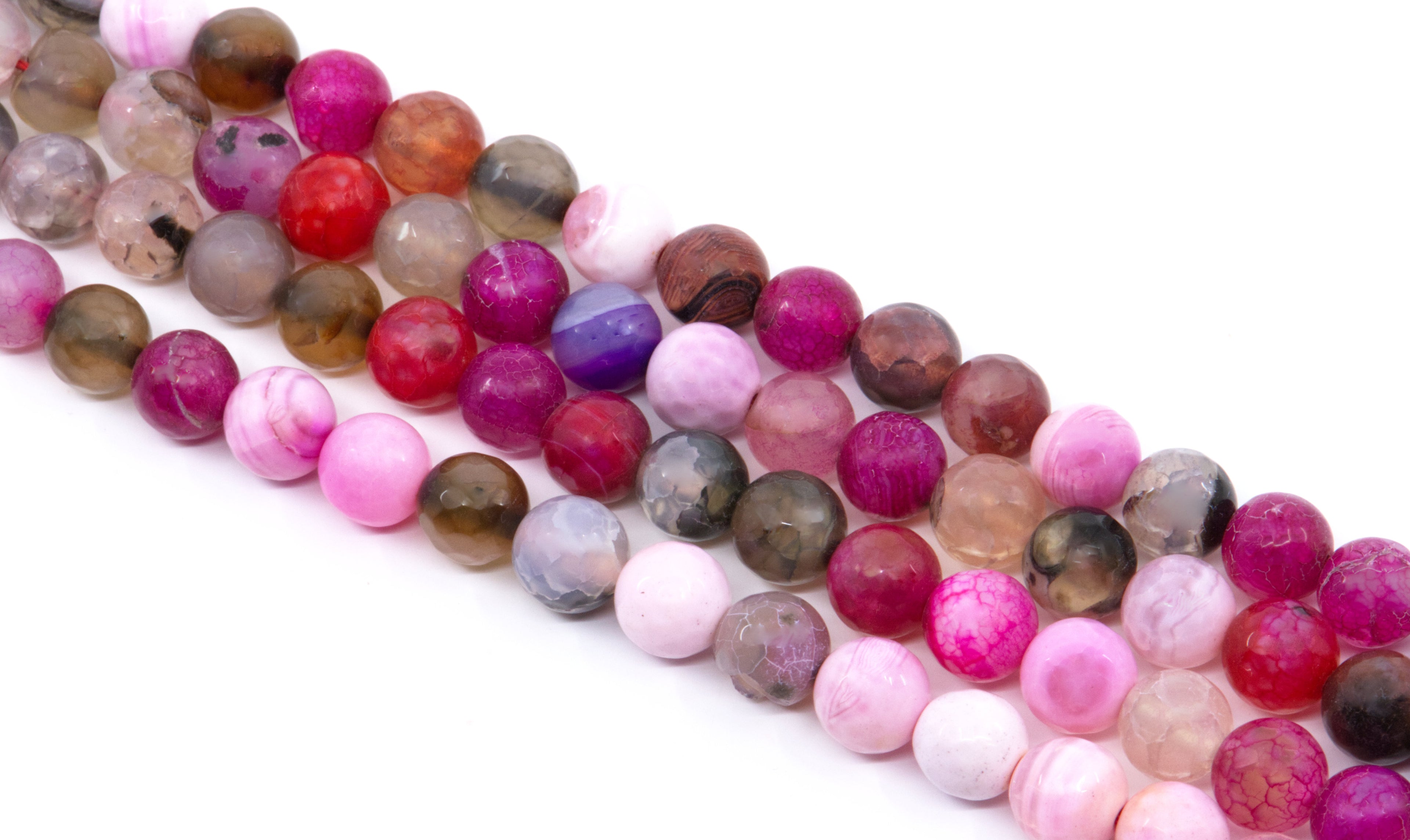 four strands of polished round faceted agate beads in various colors and , including pink, red, purple, brown, and smoky gray, arranged diagonally on a white background.