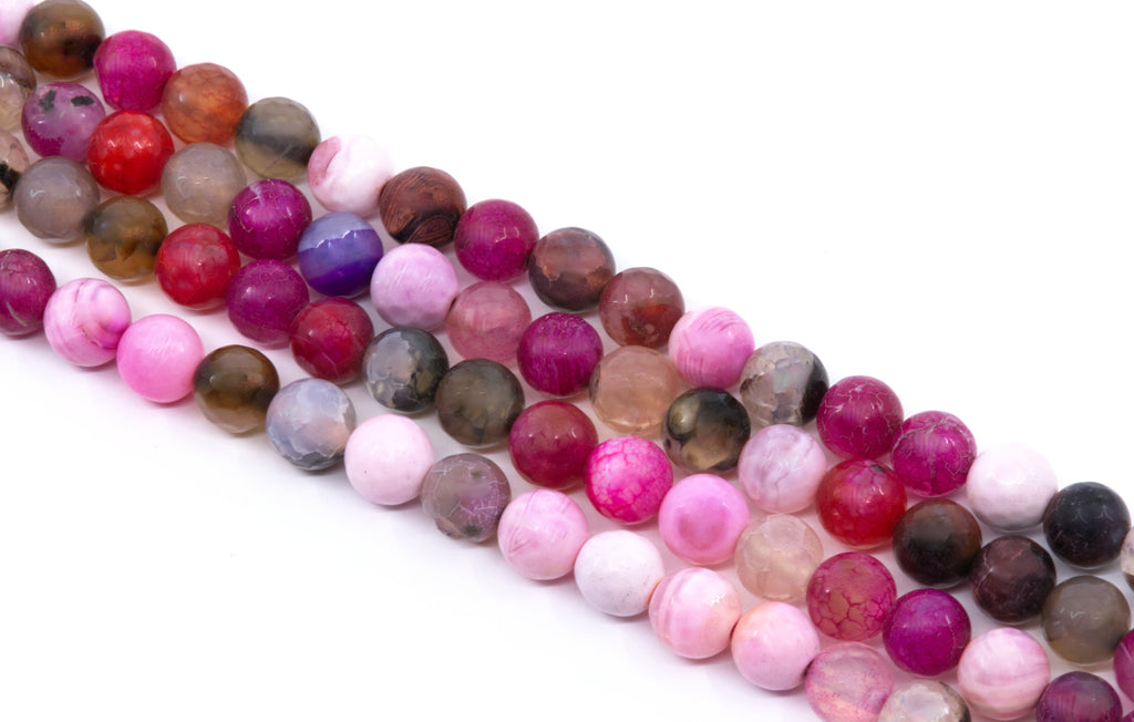 four strands of polished round faceted agate beads in various colors and , including pink, red, purple, brown, and smoky gray, arranged diagonally on a white background.