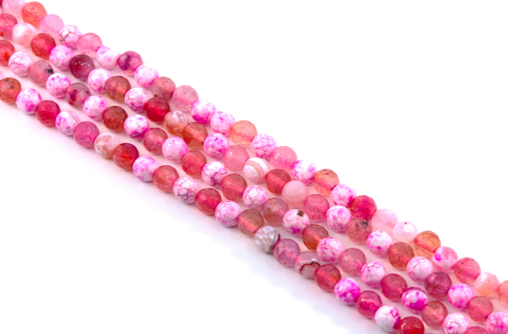 Four strands of round pink and red faceted agate beads , arranged diagonally on a white background.