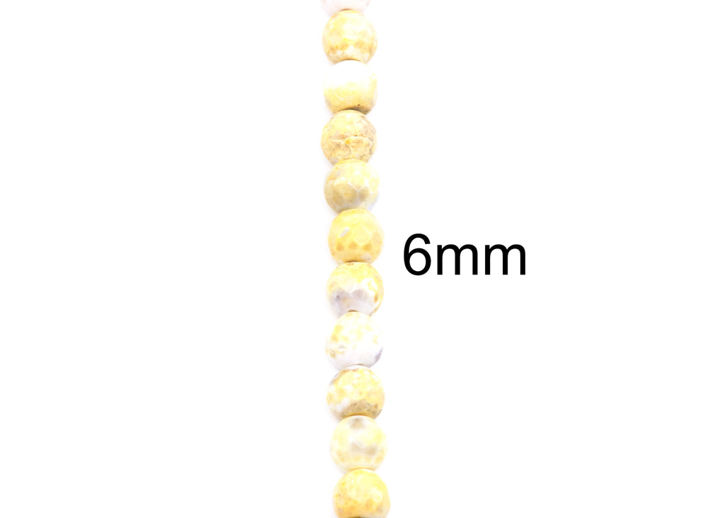 A vertical strand of round, faceted yellow and white beads with a black '6mm' text overlay on a plain white background.
