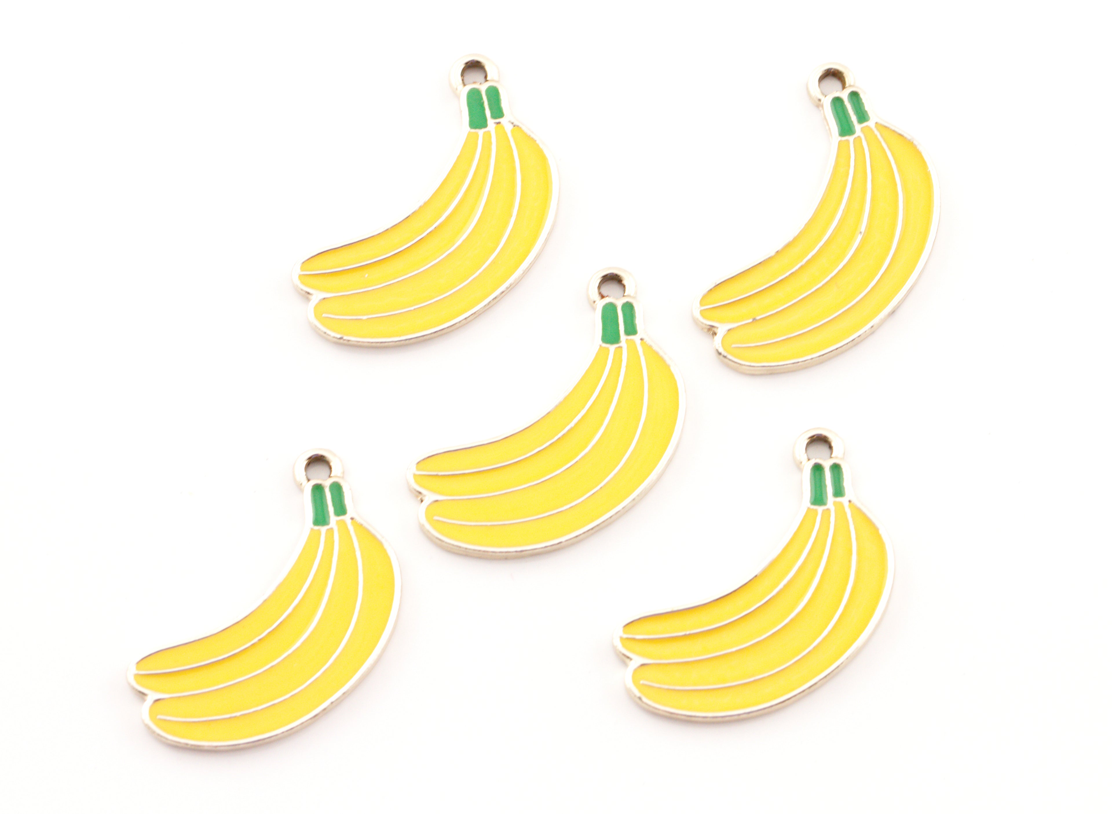 Five yellow banana-shaped charms with green stems and gold metal loops, arranged on a plain white background.