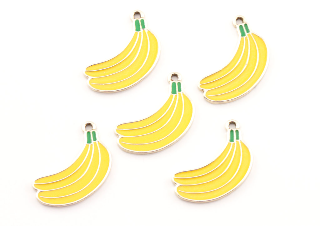 Five yellow banana-shaped charms with green stems and gold metal loops, arranged on a plain white background.