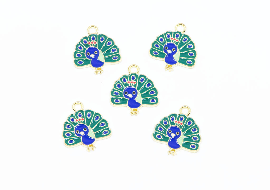 Five peacock-shaped jewelry charms with gold-tone metal borders and loops, featuring blue and green enamel detailing on a white background.