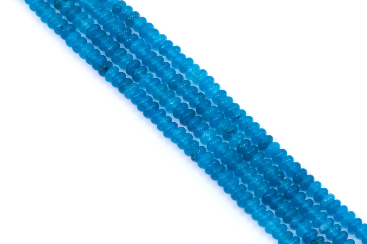 Multiple strands of small, rondelle dyed blue jade beads arranged diagonally on a plain white background.