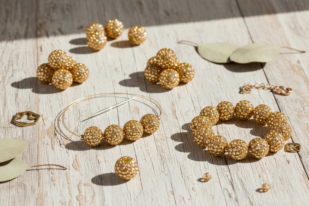 champagne colored rhinestone bubblegum beads displayed in a DIY bracelet craft project on a white wooden surface. 