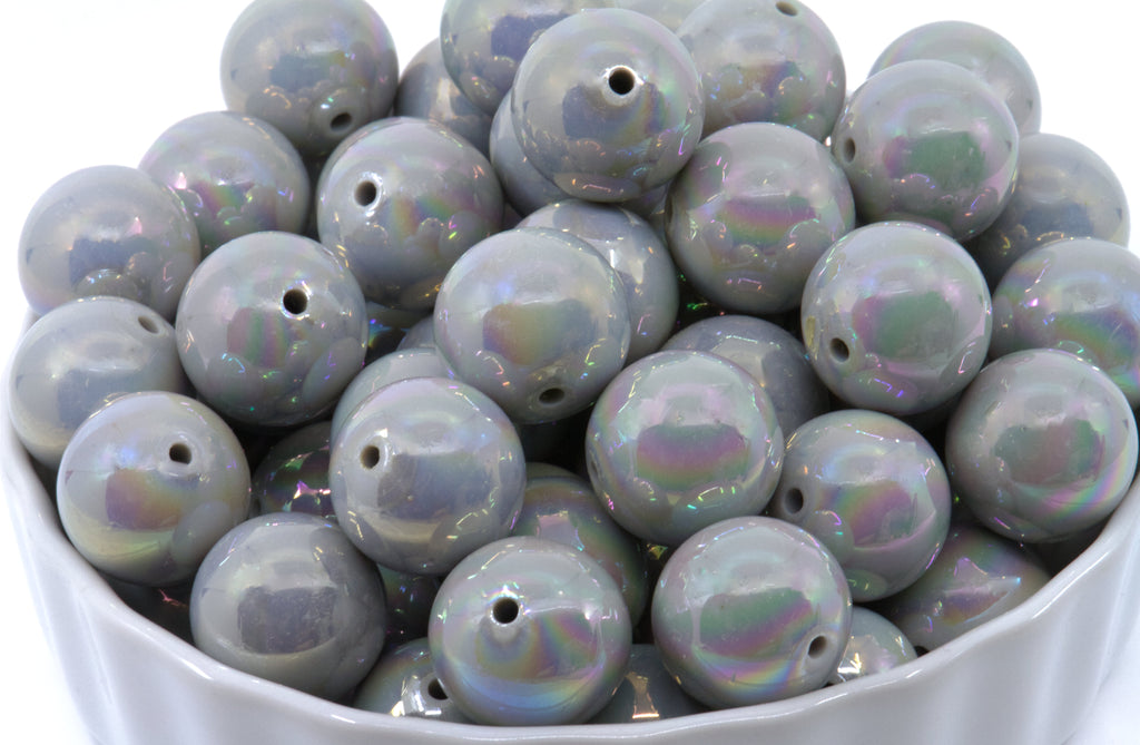 gray iridescent round beads in a white bowl on a white background
