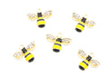 Five gold bumblebee charms with yellow and black striped bodies and clear rhinestone wings, arranged on a plain white background.