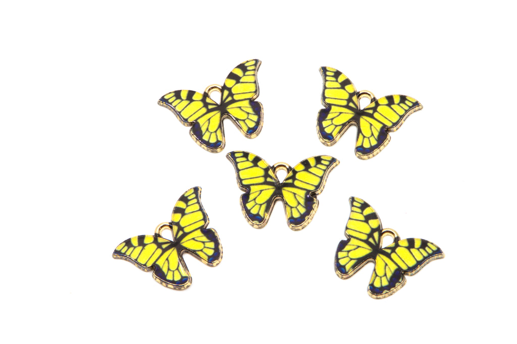 Five butterfly-shaped jewelry charms with bright yellow and black striped wings and gold-tone edges, arranged on a plain white background.