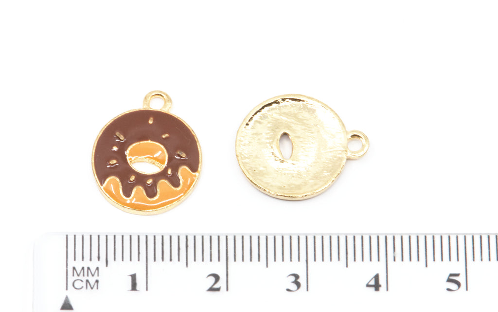 Two small round donut-shaped charms or pendants shown on a white background with a ruler at the bottom for scale. 