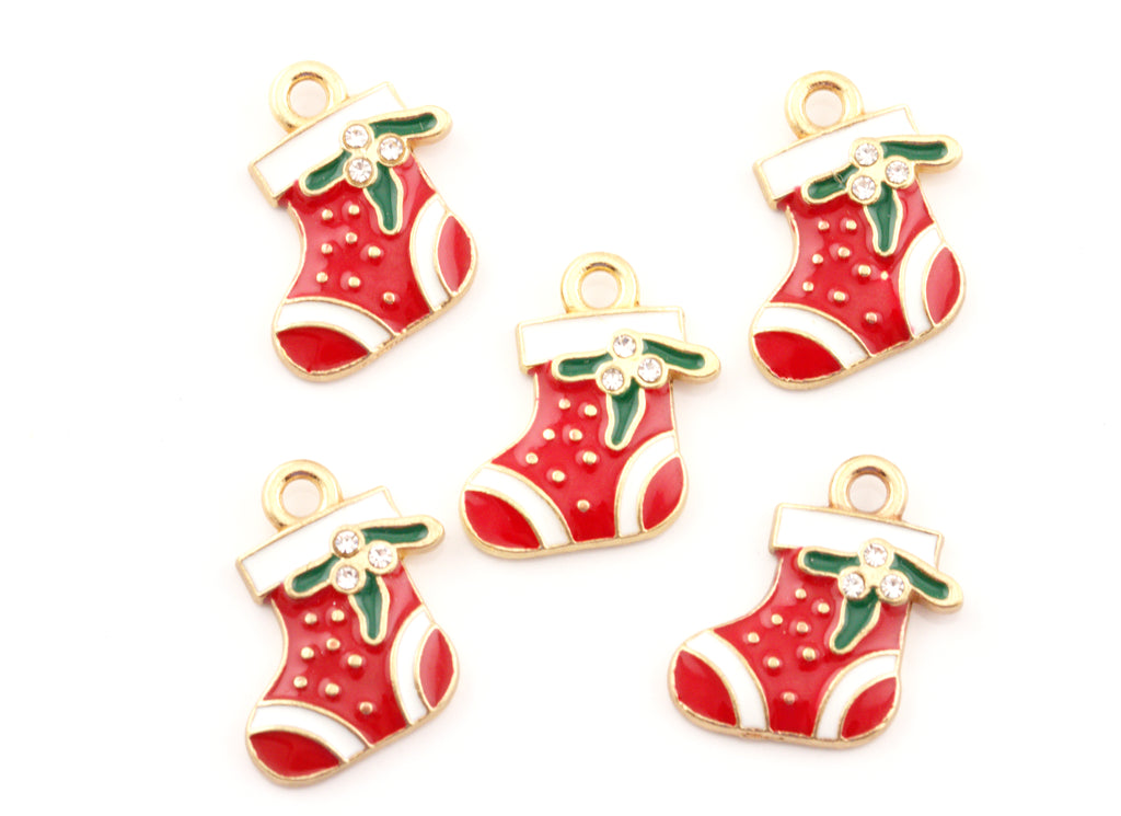Five Christmas stocking charms with red enamel, white trim, green holly leaves, and gold-tone metal borders on a plain white background.
