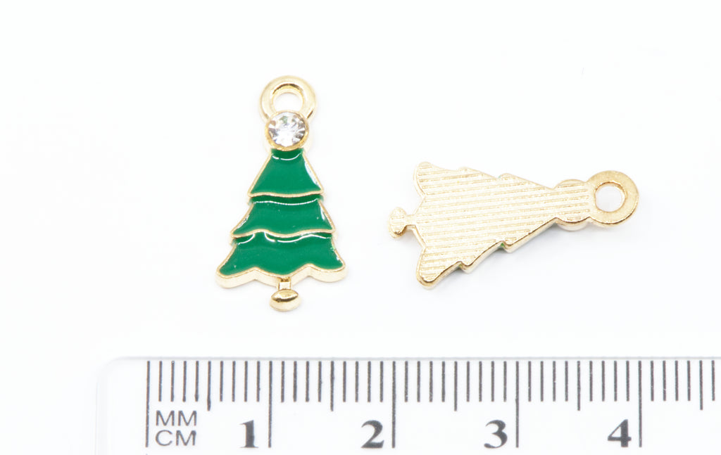 Two small gold-tone Christmas tree charms shown next to a cm ruler for scale on a white background.