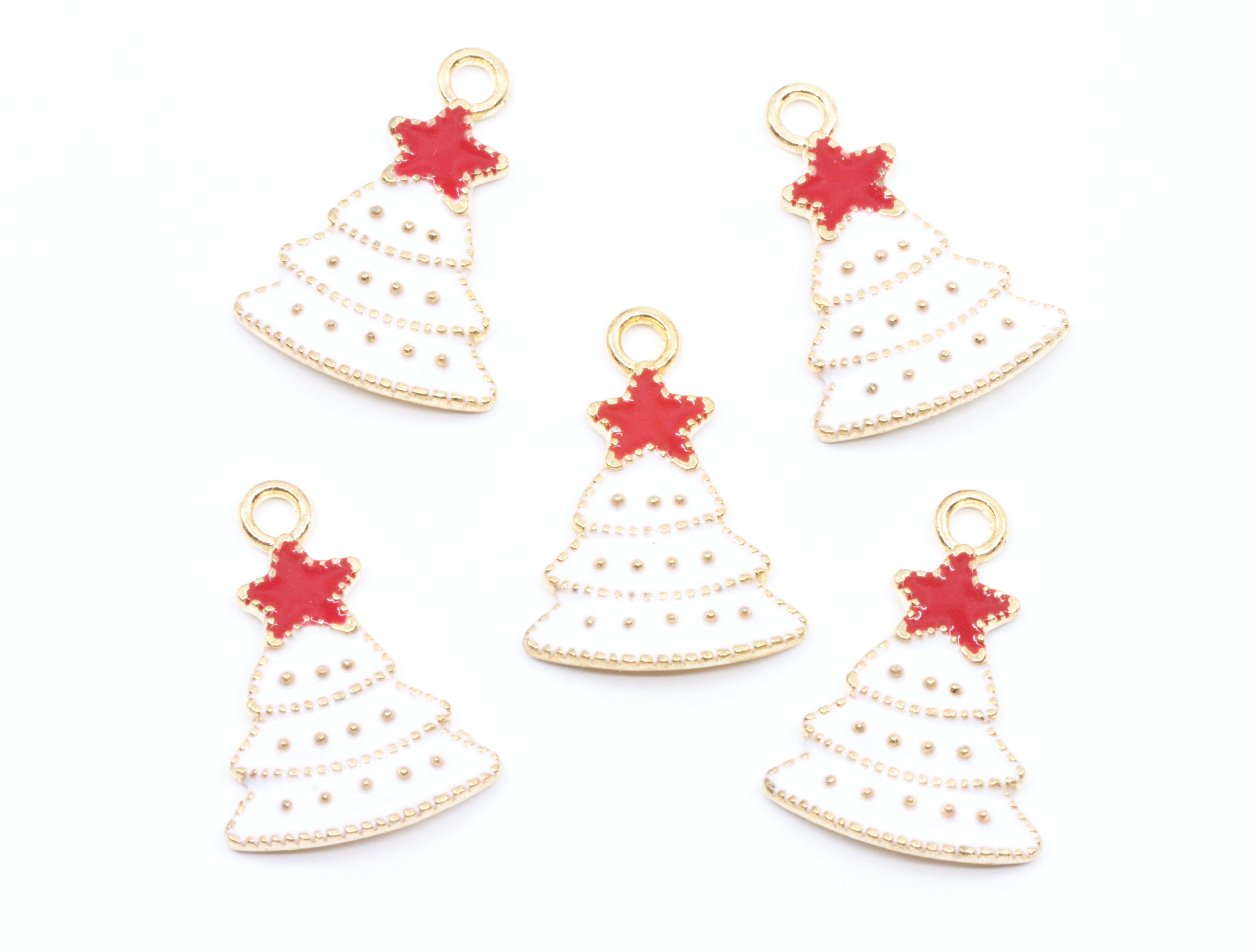 Five Christmas tree-shaped jewelry charms with gold-tone metal borders, white enamel fill, and red star toppers, arranged on a plain white background.