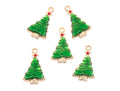 Five green Christmas tree charms with gold-tone borders and small red accents, arranged on a plain white background.