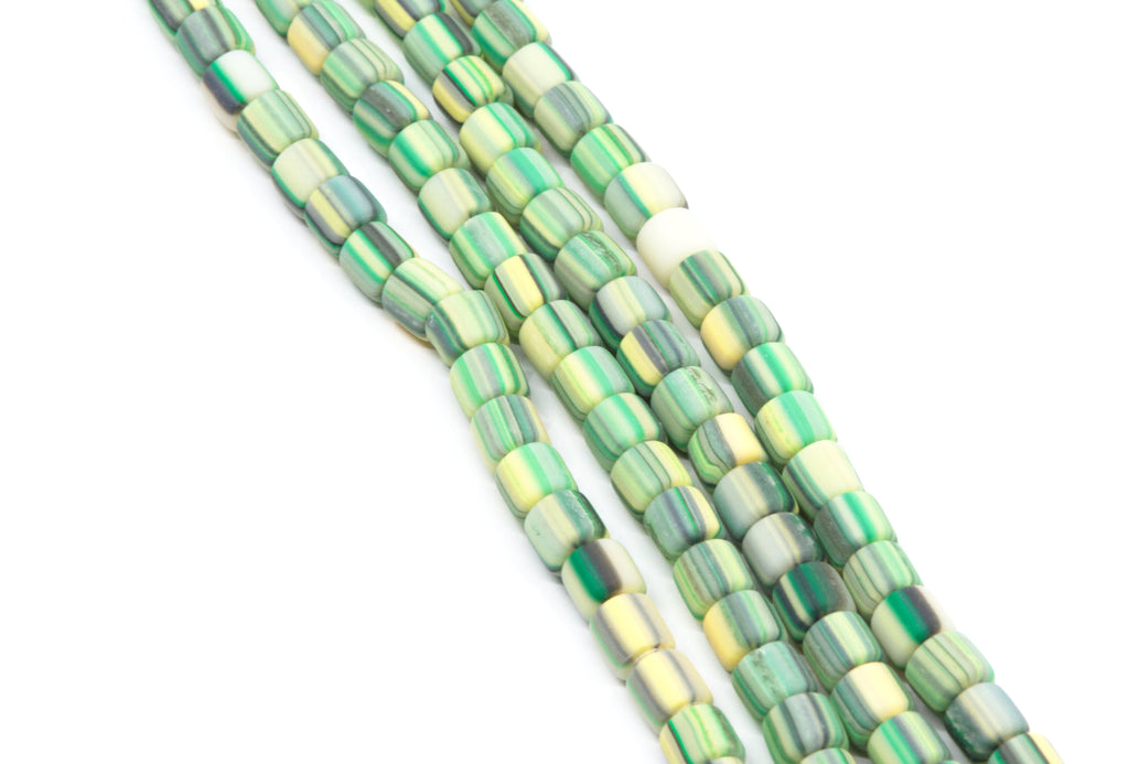 Green and yellow striped polymer clay barrel beads strands on a white background. 
