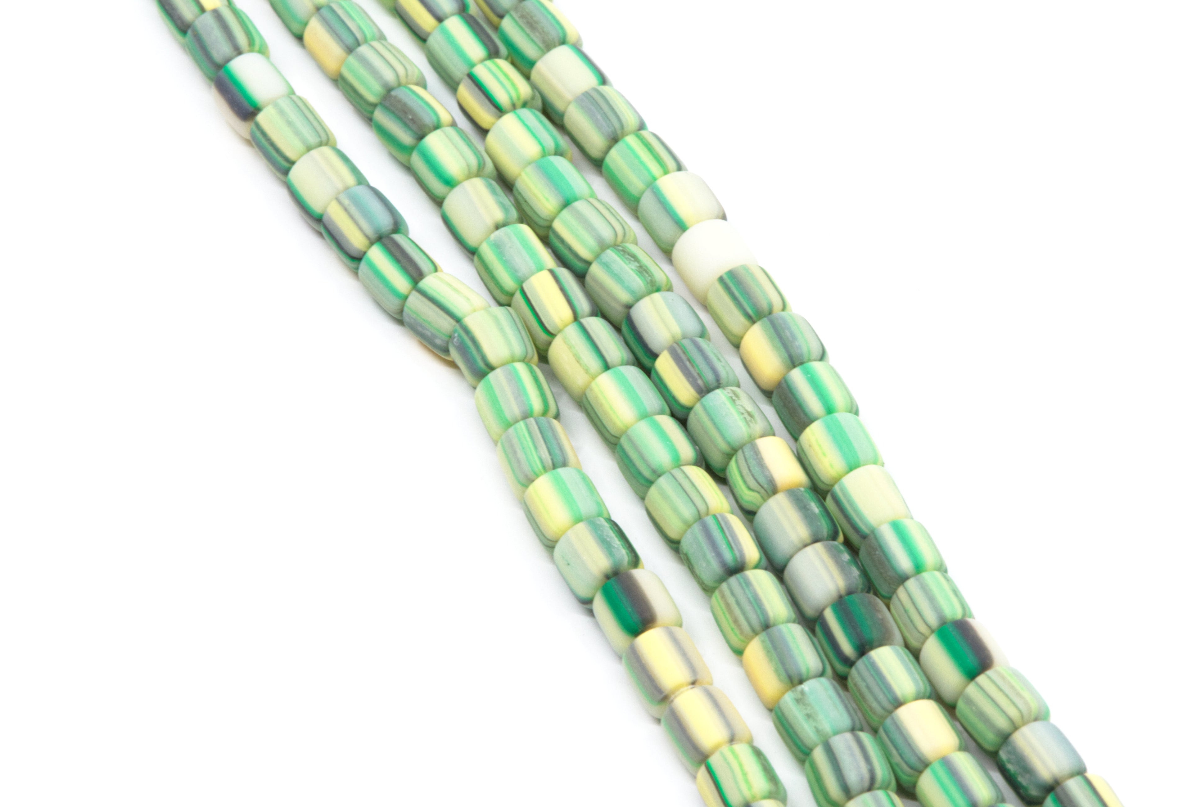 Green and yellow striped polymer clay barrel beads strands on a white background. 