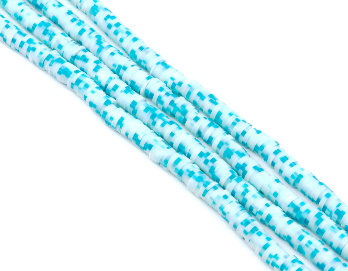 Several strands of blue polymer clay disc beads arranged diagonally on a plain white background.