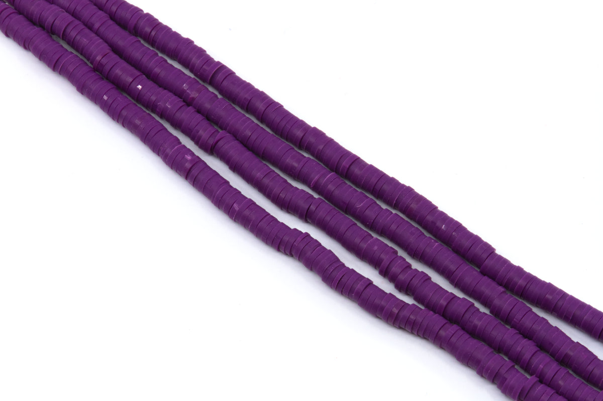 multiple strands of purple polymer clay disc beads arranged diagonally on a plain white background.