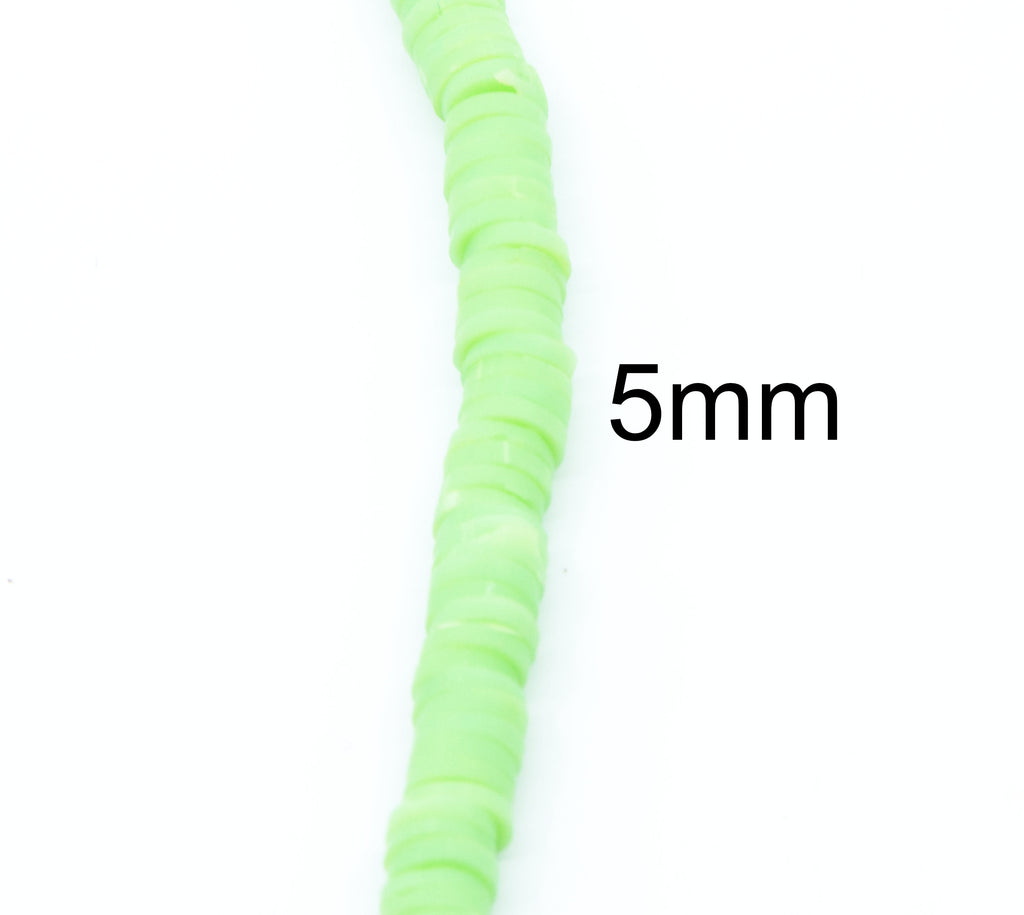 A close-up of a strand of light green, polymer clay disc-shaped beads, with a black text overlay reading '5mm' indicating the bead size, on a plain white background.