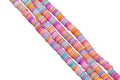 Four strands of orange and pink polymer clay disc beads  on a white background. 