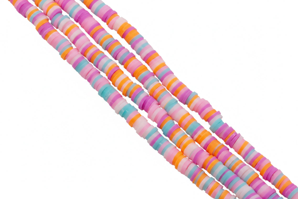 Four strands of orange and pink polymer clay disc beads  on a white background. 