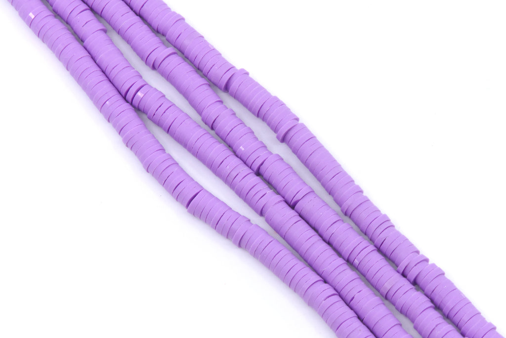 multiple strands of purple polymer clay disc beads arranged diagonally on a plain white background.