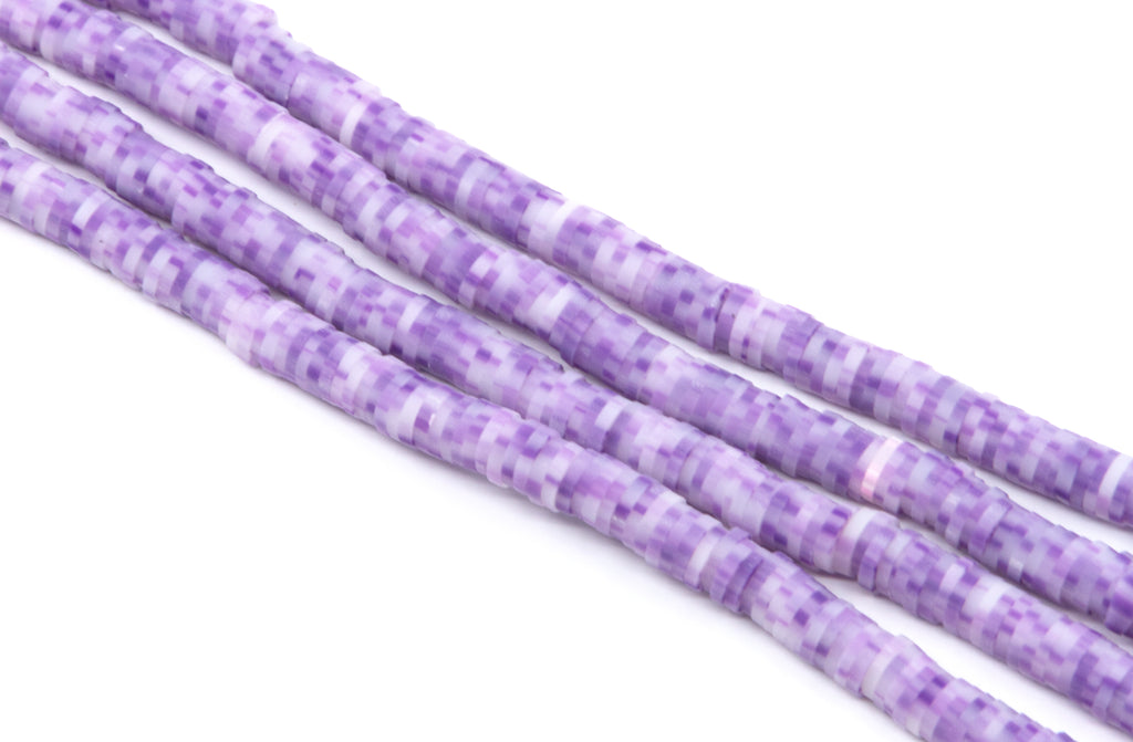 Purple and white polymer clay beads arranged in diagonal strands on a plain white background.