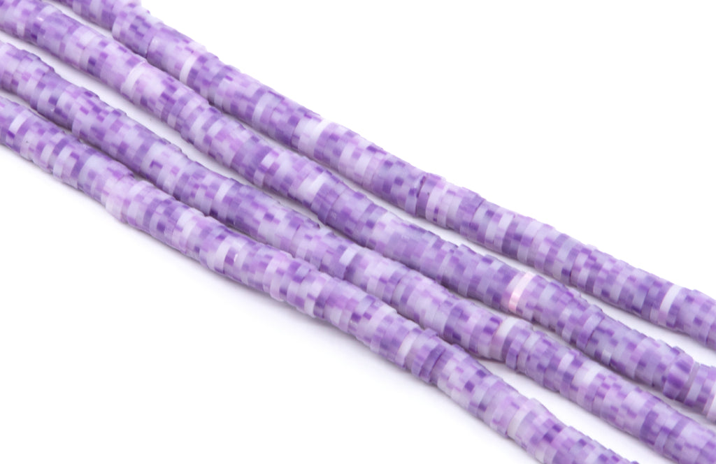 Purple and white polymer clay beads arranged in diagonal strands on a plain white background.